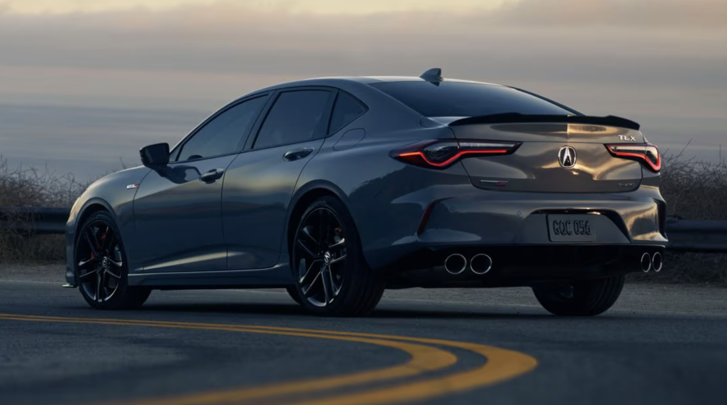 2025 Acura TLX type 2 in gray pearl color driving on road at sunset