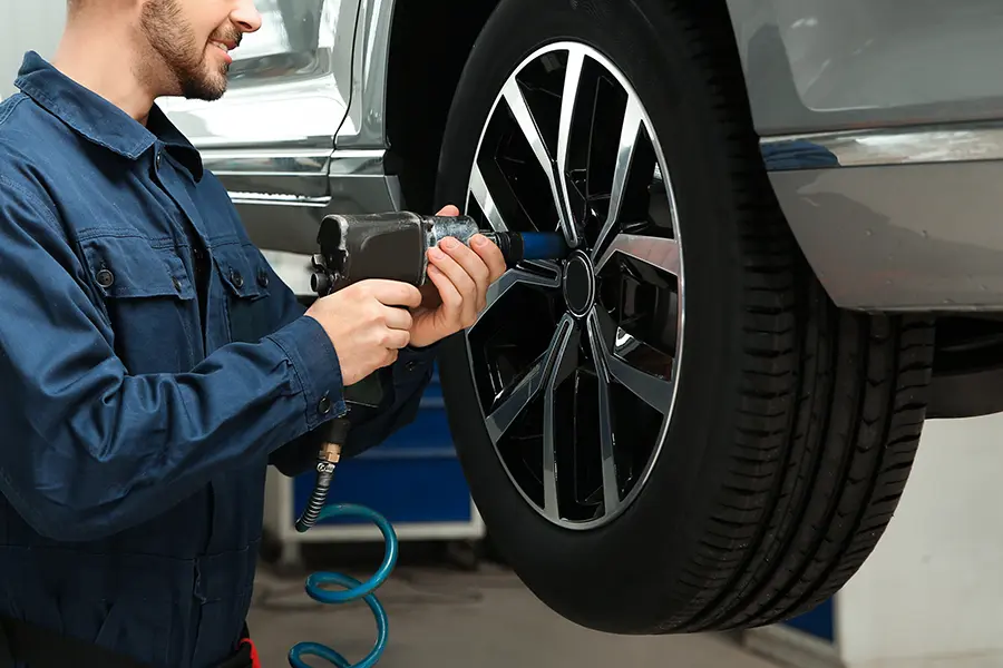 A mechanic rotating a tire - Why Tire Rotation Matters More Than You Think in Denver, CO